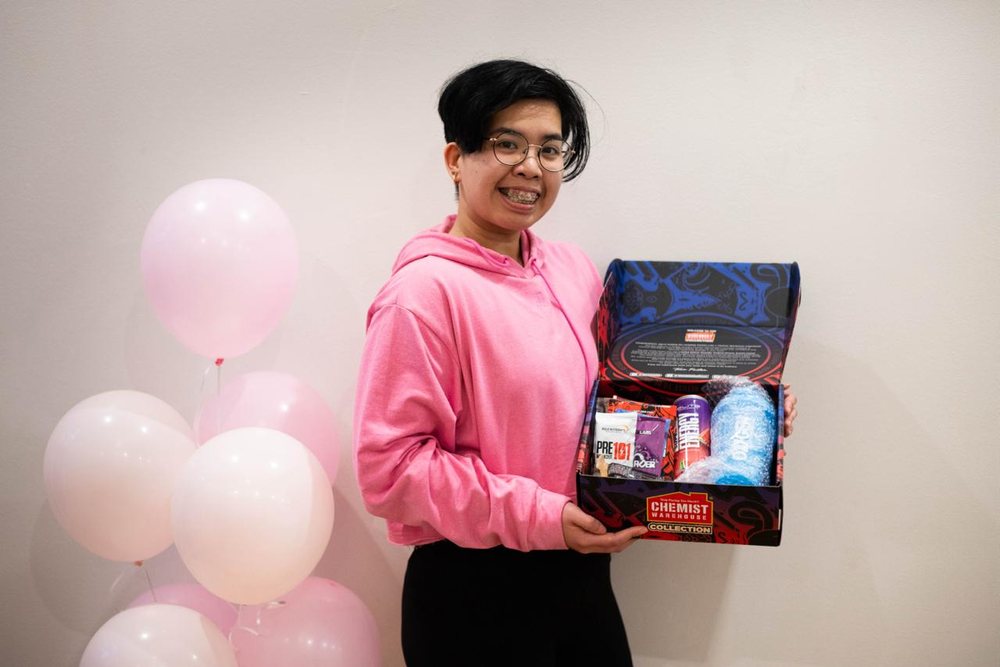 A member with her Revive prize pack